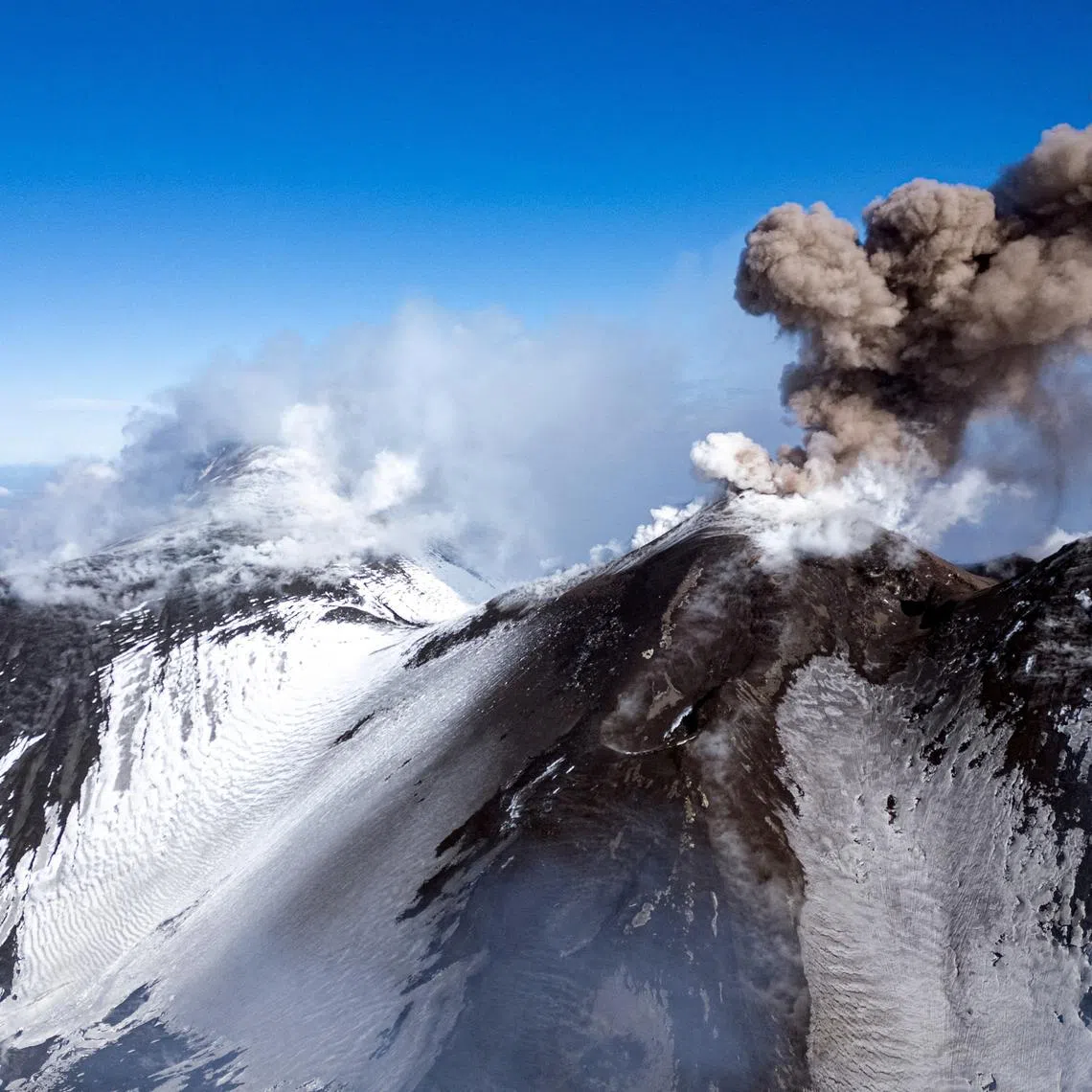 FILE PHOTO: Volcanic steam and ashes rise from Mount Etna, Italy, February 12, 2025. REUTERS/Etna Walk/Giuseppe Di Stefano/File Photo