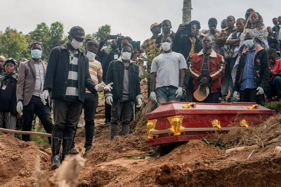 Relatives attending the funeral of an eight-month pregnant Congolese woman, who died of Ebola, and her foetus in Butembo, Democratic Republic of Congo on Oct 5.