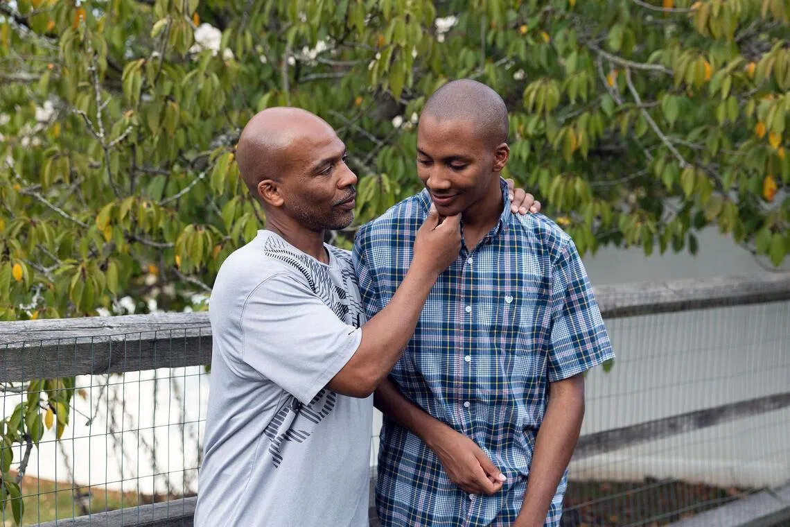 LeVar Baxter, left, with his son Khalil, 21, who does not talk and cannot live independently.