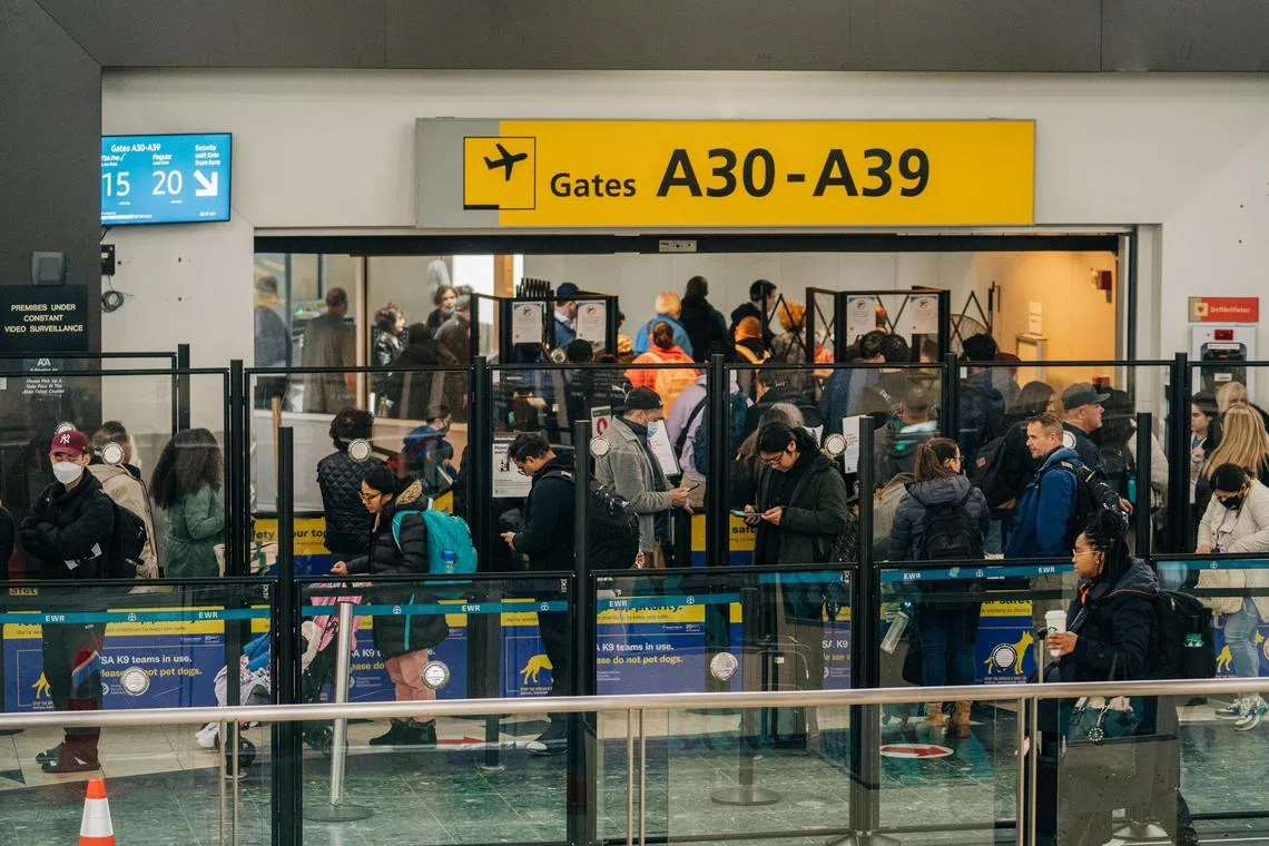 Travellers wait in security inspection lines at Newark Liberty International Airport in New Jersey on the morning of Jan 11, 2023. Flights were taking off again after an early morning Federal Aviation Administration system failure left pilots, airlines and airports without crucial safety information.