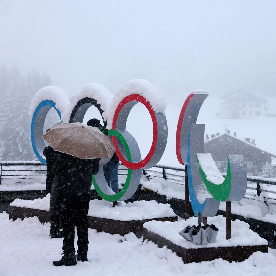 FILE PHOTO: Milano Cortina 2026 Winter Olympics - Previews - Cortina d'Ampezzo, Italy - January 25, 2026 General view of the Olympic rings and the Paralympics Agitos logo covered in snow ahead of the Milano Cortina 2026 Winter Olympics REUTERS/Claudia Greco/File Photo