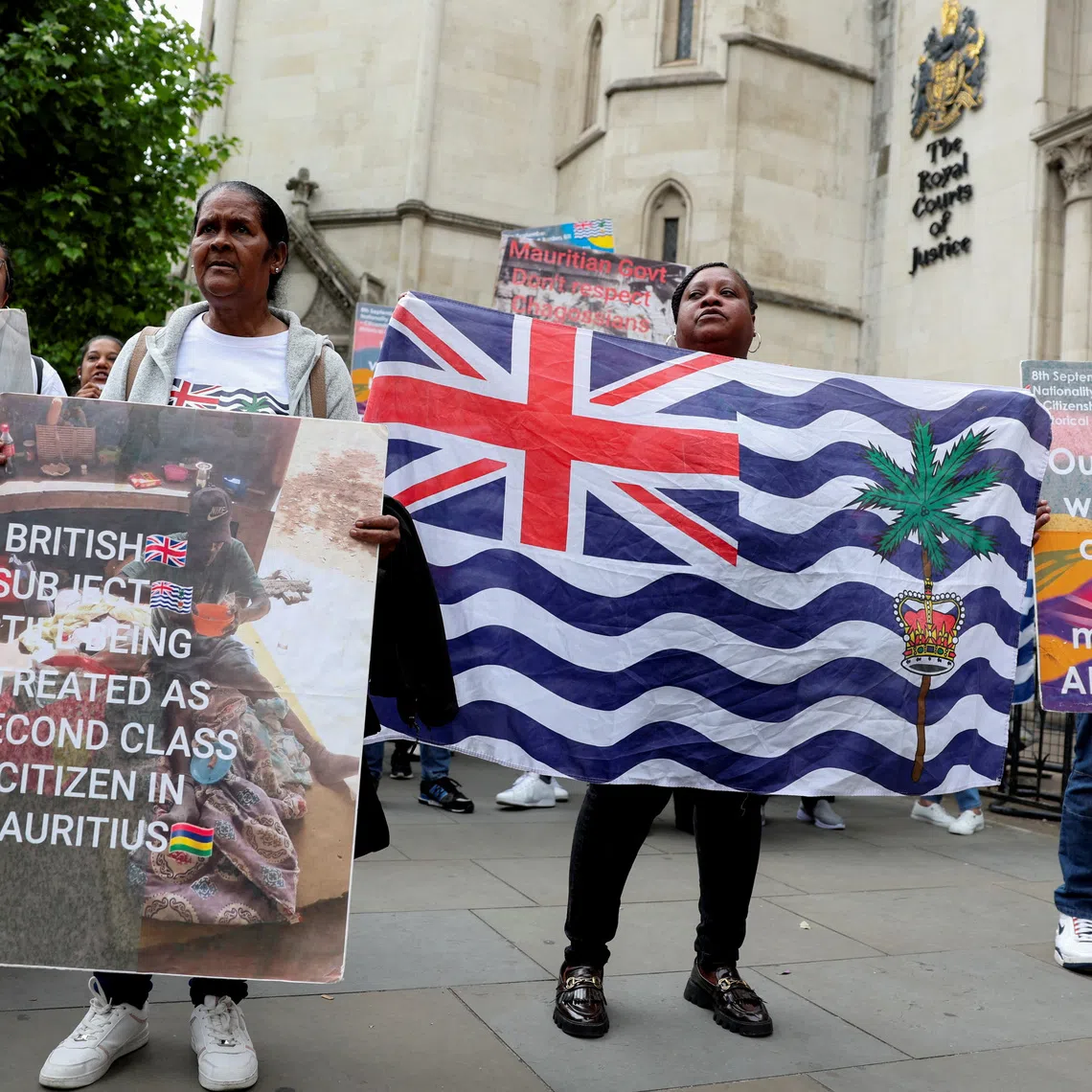FILE PHOTO: Members of the British Chagossian community demonstrate, as they wait to hear the outcome of a court injunction that temporarily blocked the UK from concluding Chagos Islands deal with Mauritius, outside the High Court in London, Britain, May 22, 2025. REUTERS/Suzanne Plunkett/File Photo
