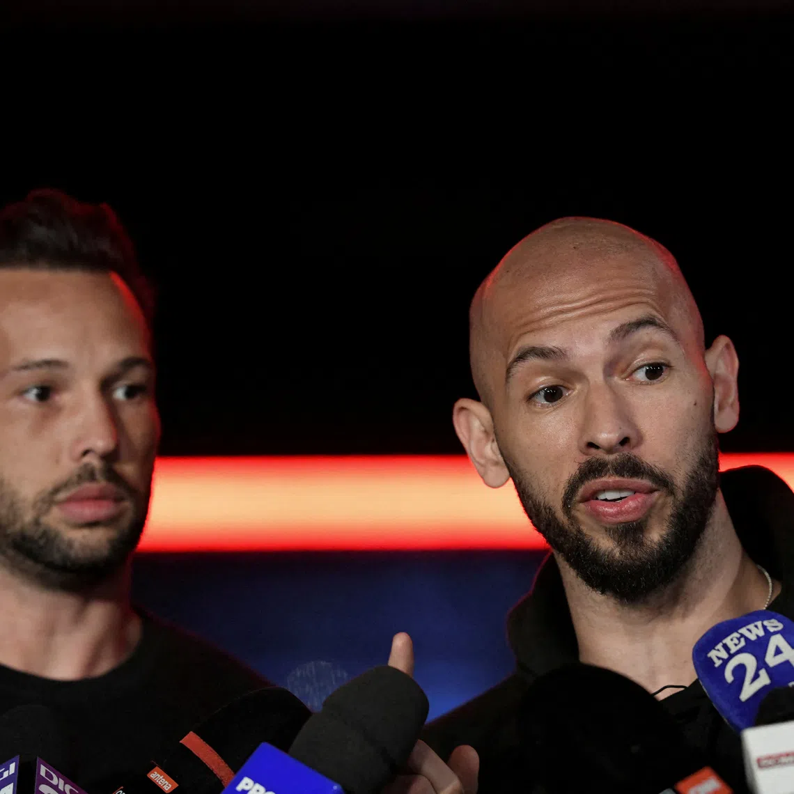 FILE PHOTO: Tristan and Andrew Tate deliver a press statement in front of their house after landing back in Romania, near Bucharest, Romania, March 22, 2025. Inquam Photos/Eduard Vinatoru via REUTERS
