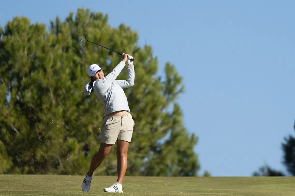 Singaporean golfer Shannon Tan is seven strokes behind leader Leah John from Canada.