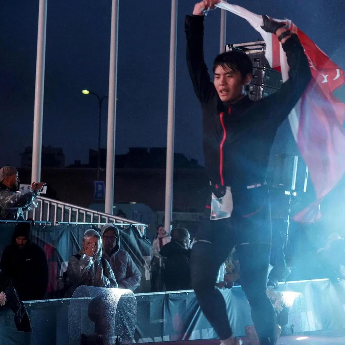 ACJC student Xie Ze Kai, 18, crosses the finishing line at Ironman Tallinn. He completed the race in 12:38:24.