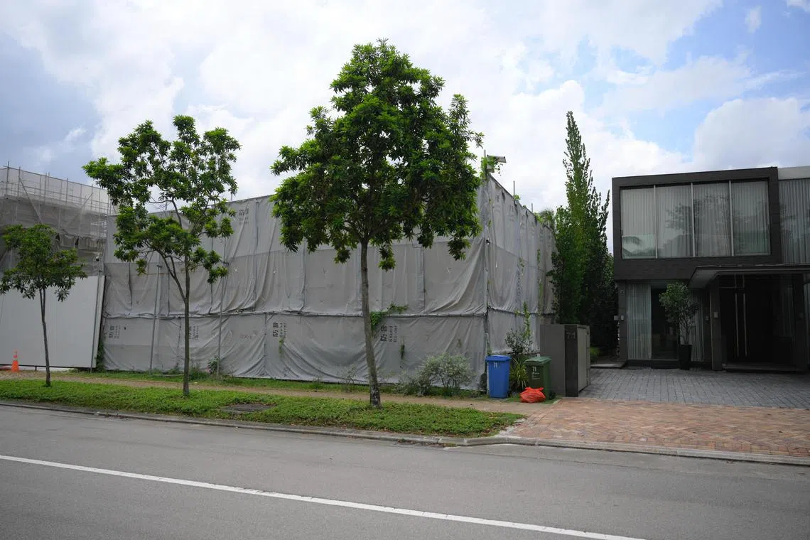 The plot of land (left, covered by sound barricade) at 69 Ocean Drive in Sentosa Cove which is up for sale, pictured on 15 April 15, 2024.