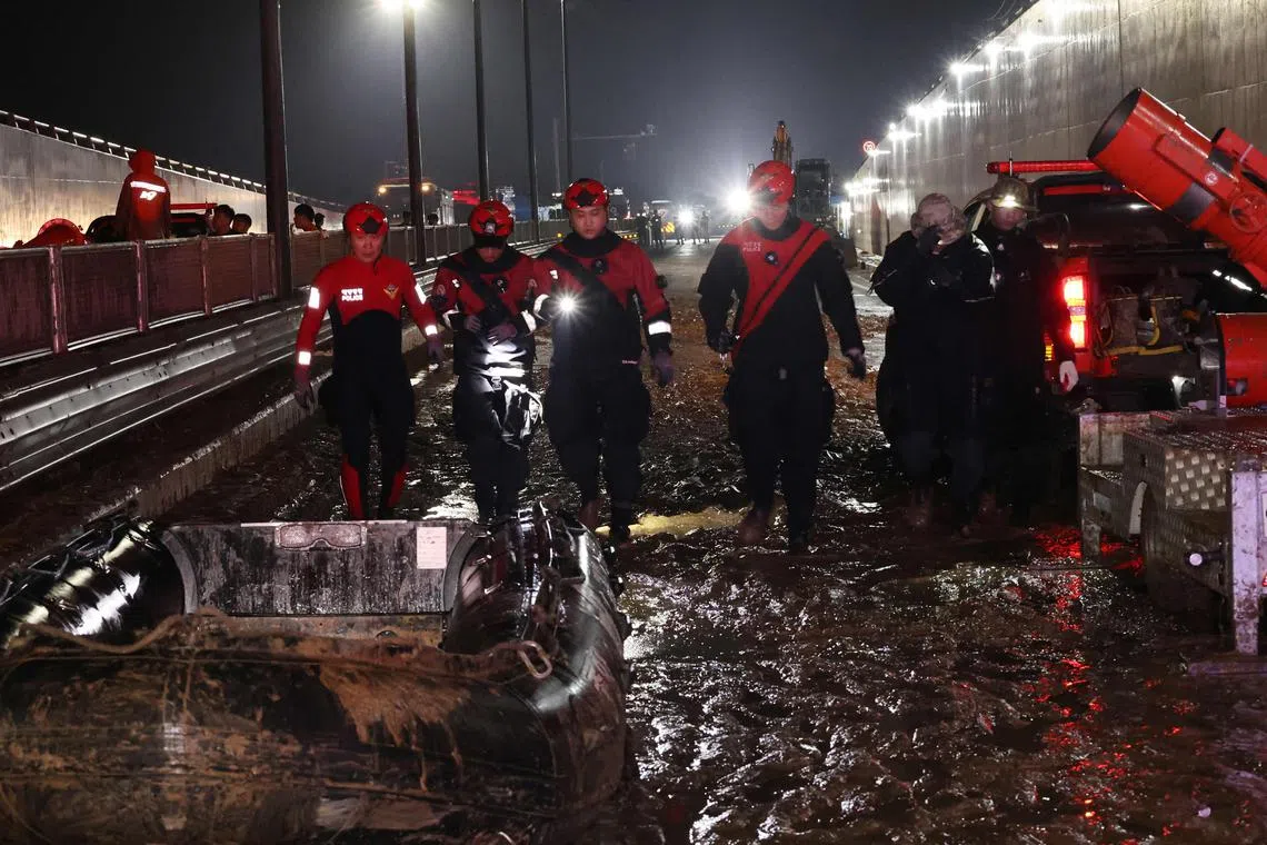 Rescue workers search for missing people along an underground tunnel.