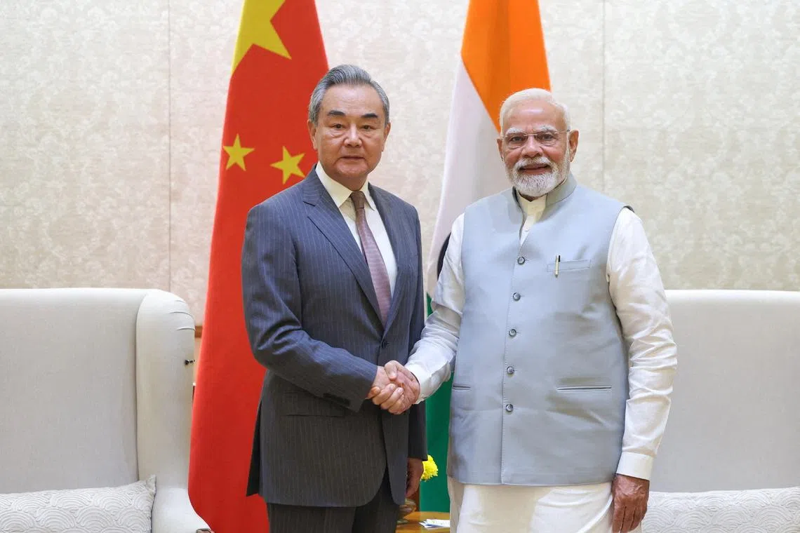 FILE PHOTO: India's Prime Minister Narendra Modi shakes hand with Chinese Foreign Minister Wang Yi during their meeting in New Delhi, India August 19, 2025. India's Press Information Bureau/Handout via REUTERS/File Photo