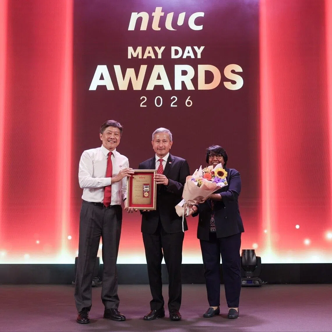 Foreign Minister Vivian Balakrishnan (centre) receiving the Medal of Honour - the labour movement’s top May Day award - from NTUC secretary-general Ng Chee Meng (left) and NTUC president K. Thanaletchimi.