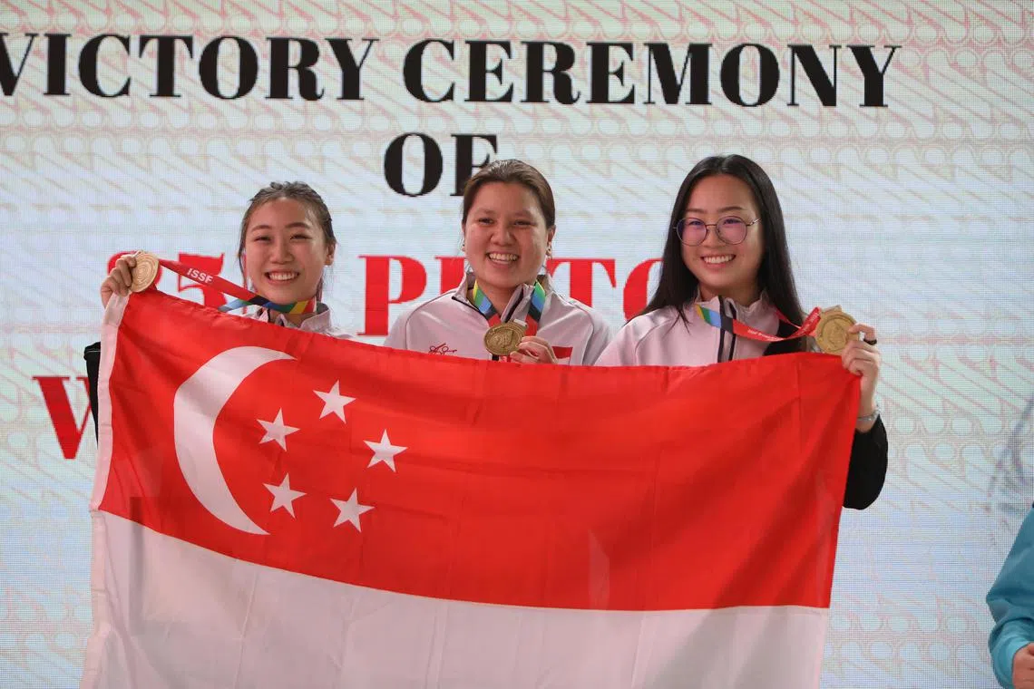 Singapore shooters Teh Xiu Yi, Teo Shun Xie and Teh Xiu Hong posing for a photo after winning gold in the women's 25m pistol team at the ISSF World Cup. They beat South Korea 16-6 in the final in Jakarta.