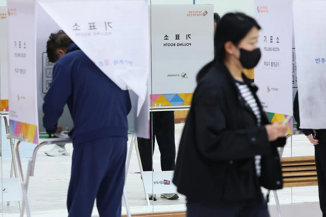 Voters cast their ballots for parliamentary elections at a polling station in the Dongjak district of Seoul, South Korea.