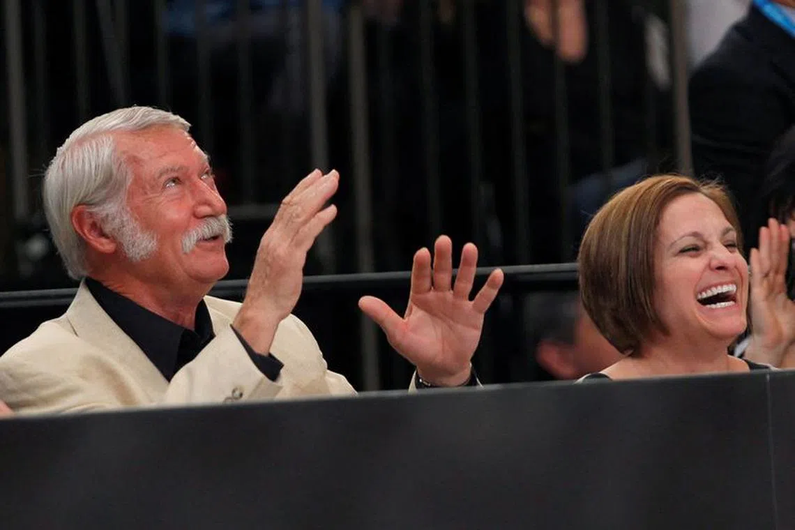 FILE PHOTO: Former Olympic Gold medallist gymnast Mary Lou Retton (R) of the U.S. and her former coach Bela Karolyi laugh as they sit next to the floor during the AT&T American Cup gymnastics competition at New York's Madison Square Garden March 3, 2012. REUTERS/Mike Segar/File Photo