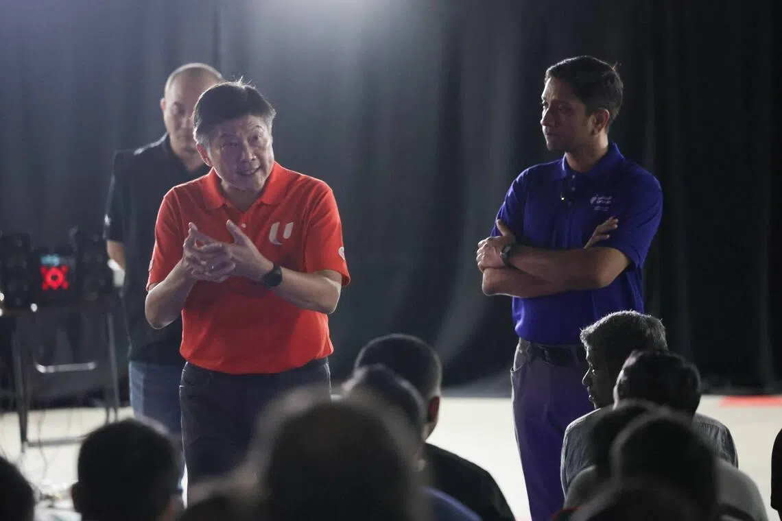NTUC Secretary-General Ng Chee Meng (left) and Minister of State for the Ministry of Manpower Dinesh Vasu Dash speaking to the migrant workers affected by the alleged unpaid wages involving KPA Engineering and SK Industries at Tuas View Dormitory on June 24.