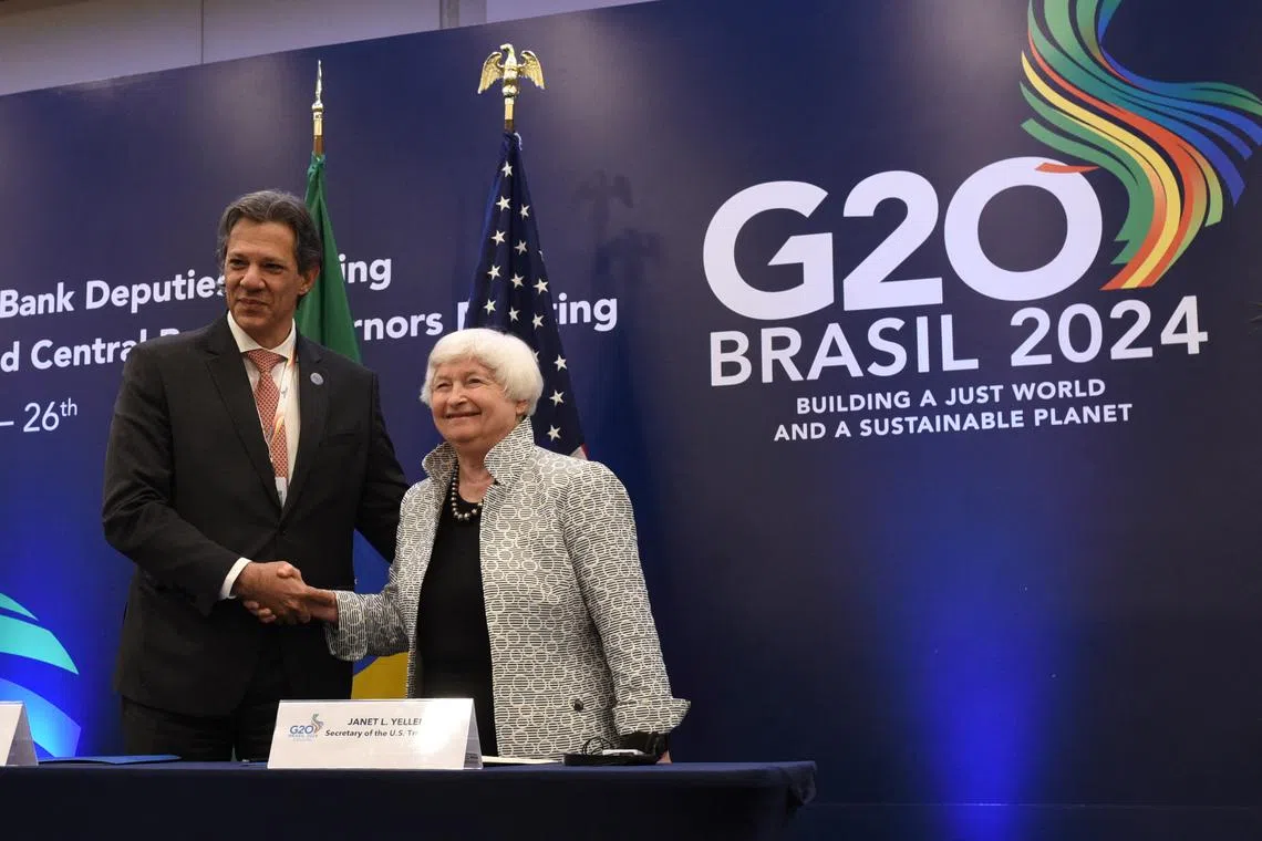 Brazil's Finance Minister Fernando Haddad shakes hands with U.S. Treasury Secretary Janet Yellen during the the G20 finance leaders' meeting in Rio de Janeiro, Brazil, July 26, 2024. REUTERS/Tita Barros