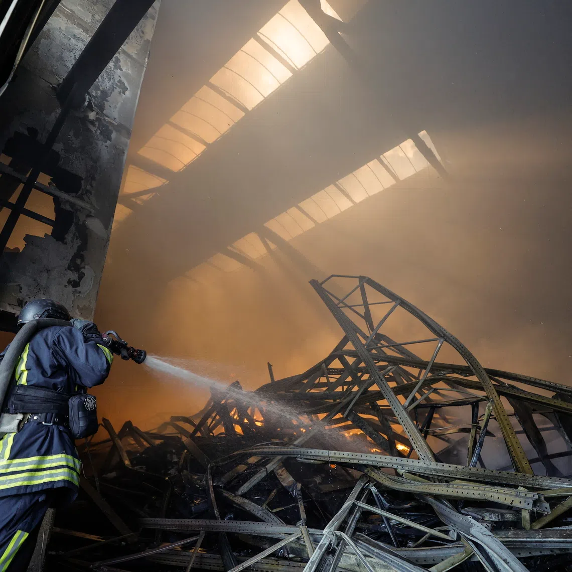 Ukrainian rescuers working at the site of a Russian drone strike on warehouses near Kyiv, on Sept 2.