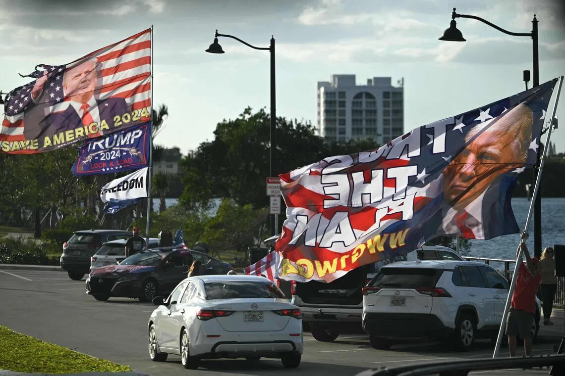 Supporters of US President Donald Trump display flags outside his Mar-a-Lago residence in Palm Beach, Florida, on Jan 16.