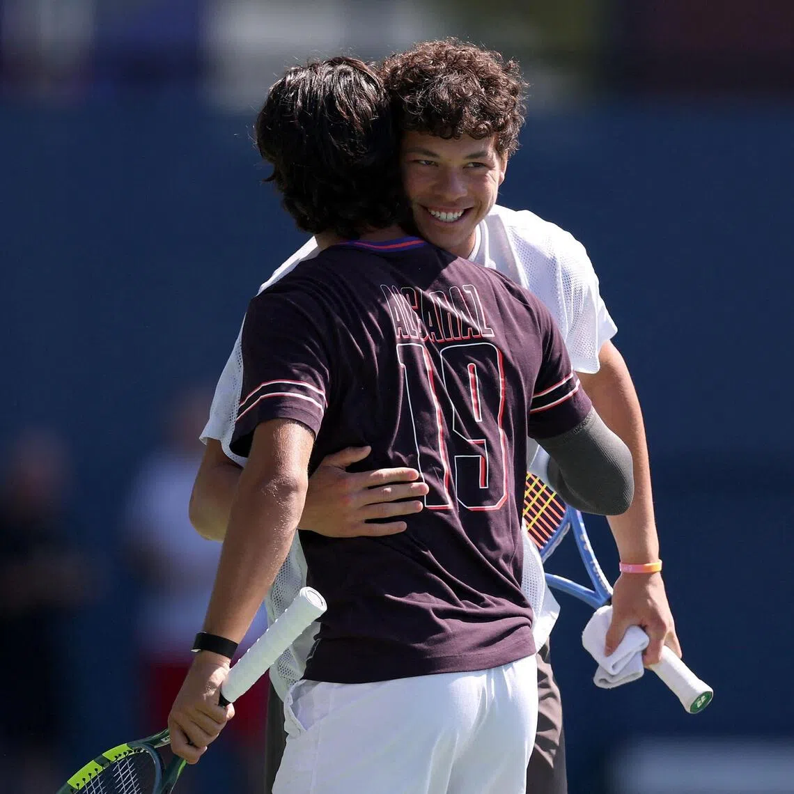 American Ben Shelton (in white) and Carlos Alcaraz of Spain embracing at a practice session during US Open Fan Week on Aug 25 in New York.