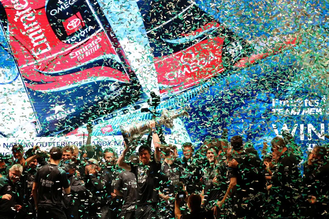 FILE PHOTO: Sailing - 37th America's Cup - New Zealand v Britain - Barcelona, Spain - October 19, 2024 Emirates Team New Zealand celebrate with the Auld Mug trophy on the podium after winning the 37th America's Cup REUTERS/Nacho Doce/File Photo