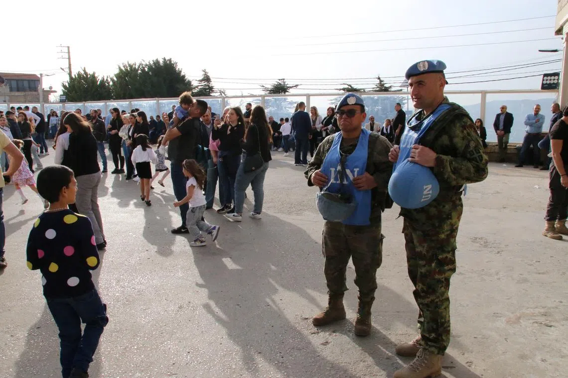 FILE PHOTO: Members of the United Nations peacekeepers (UNIFIL) stand together at the church square on Good Friday in the town of Klayaa, southern Lebanon, March 29, 2024. REUTERS/Karamallah Daher/File Photo