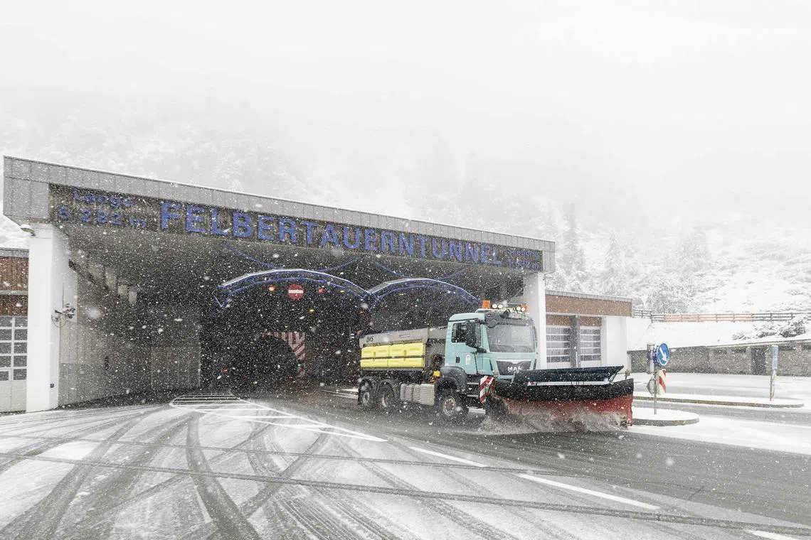 A snow plough cleans the road on the southern part of the Felbertauern tunnel in Mittersill, Austria, on September 12, 2024, where first snow fall lead to first road closures (Photo by Johann GRODER / APA / AFP) / Austria OUT