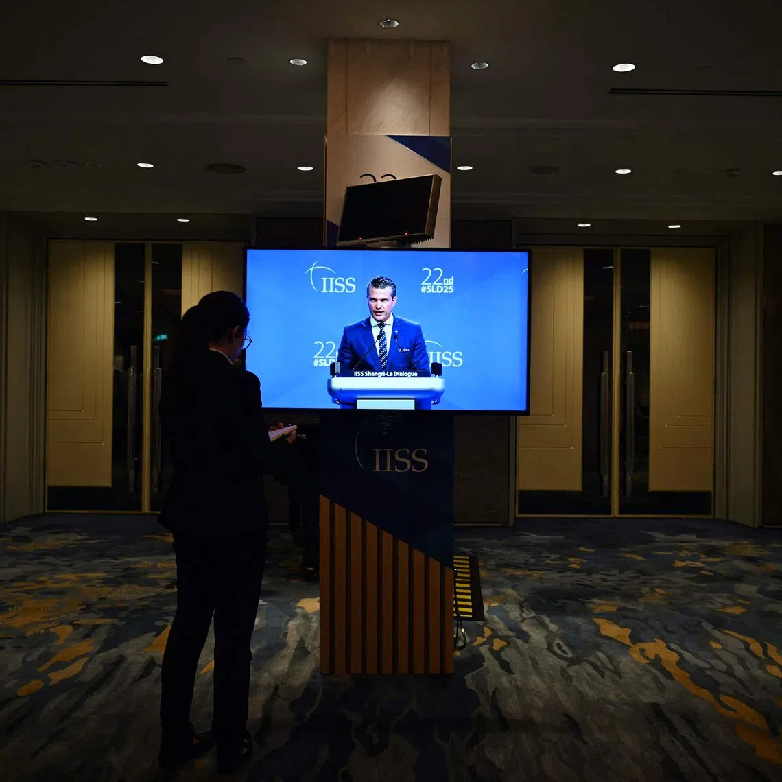 US Defence Secretary Pete Hegseth seen on a monitor delivering an address at the Shangri-La Dialogue security summit in Singapore on May 31.