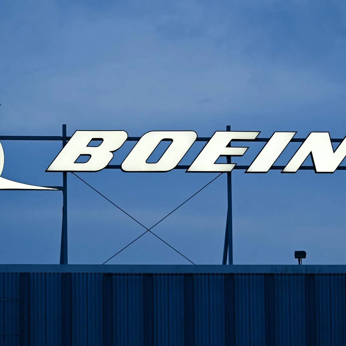 (FILES) The Boeing Co. logo is displayed outside of company offices near Los Angeles International Airport (LAX) in El Segundo, California on January 18, 2024. Boeing reported a small quarterly loss on April 22, 2026, following an uptick in commercial plane deliveries as the aerospace giant pointed to progress on a turnaround after a long period of stumbles. The US aircraft manufacturer reported a loss of $90 million in the first quarter of 2026, compared with a loss of $123 million in the year-ago period. (Photo by Patrick T. Fallon / AFP)