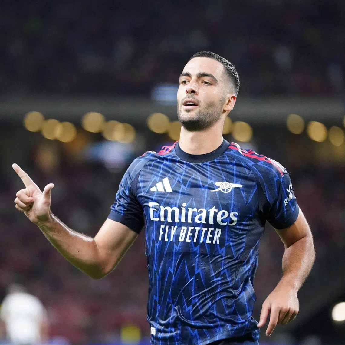 Arsenal midfielder Mikel Merino celebrating after scoring the team's first goal during their pre-season friendly against Newcastle United at the National Stadium.