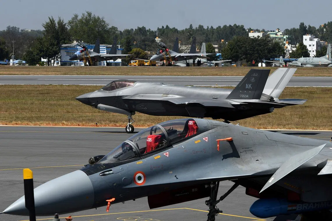 FILE PHOTO: A F-35 fighter jet moves past Indian Air Force's Sukhoi Su-30MKI fighter jet parked on tarmac during the \"Aero India 2025\" air show at Yelahanka air base in Bengaluru, India, February 11, 2025. REUTERS/Stringer/File Photo