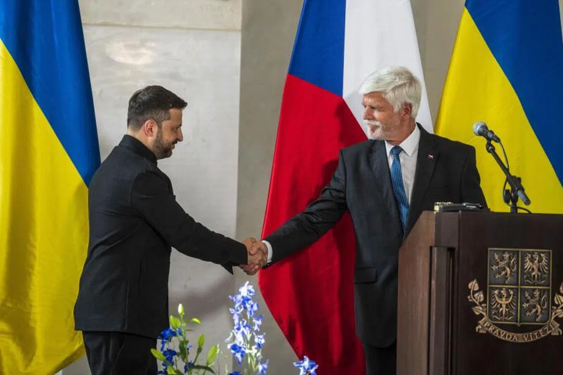 Volodymyr Zelenskiy, Ukraine's president, left, and Petr Pavel, Czech Republic's president, shake hands during a news conference at Prague Castle in Prague, Czech Republic, on Sunday, May 4, 2025. Ukraine wants to host a meeting of national security advisers at a yet-to-be-determined date to discuss further steps in the peace process, said President Zelenskiy. Photographer: Milan Jaros/Bloomberg