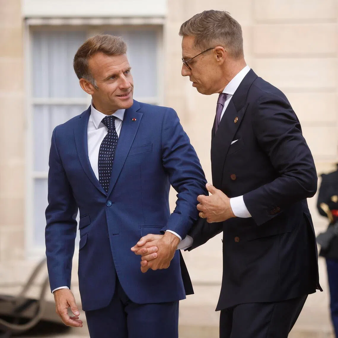 French President Emmanuel Macron (left) greets Finnish President Alexander Stubb upon his arrival at the Elysee Palace in Paris on Sept 10.