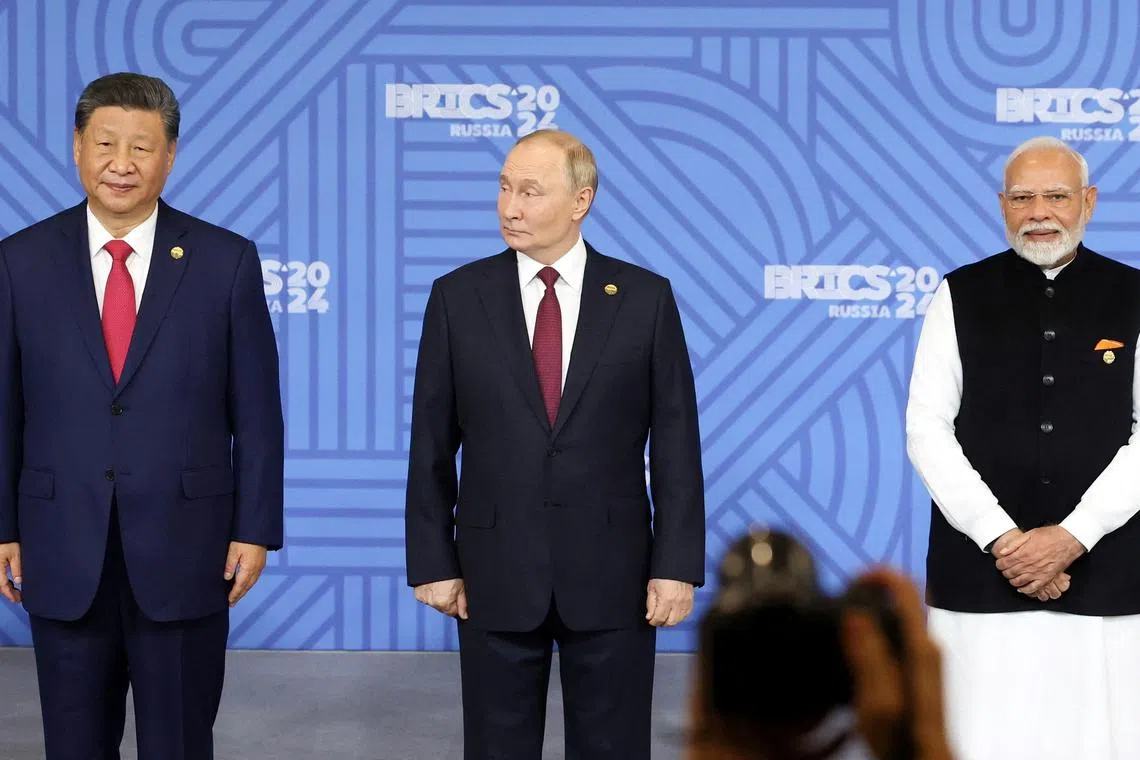 Chinese President Xi Jinping, Russian President Vladimir Putin and Indian Prime Minister Narendra Modi take part in a photo ceremony before a plenary session of the BRICS 2024 summit in Kazan, Russia October 23, 2024. Sputnik/Alexander Kazakov/Pool via REUTERS