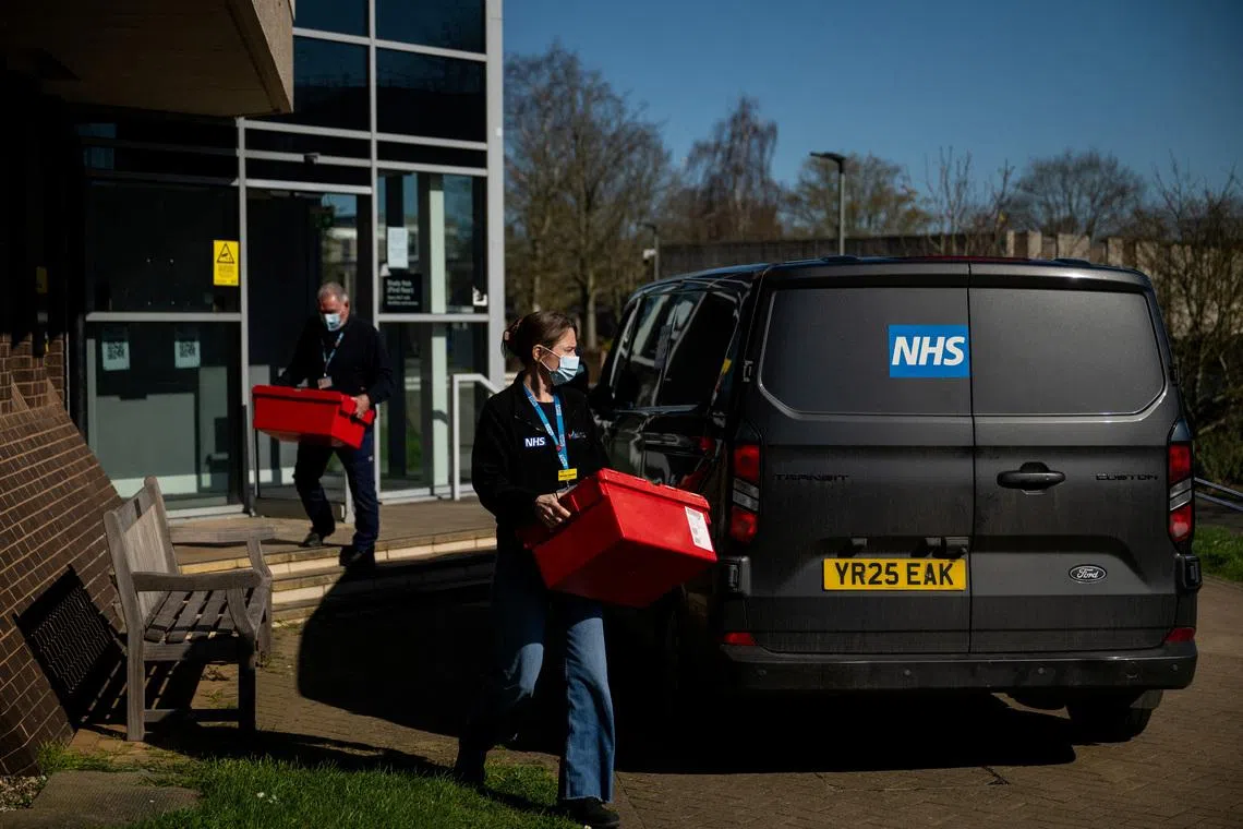 National Health Service (NHS) workers carry boxes from a building that is supplying antibiotics on the University of Kent campus following an outbreak of meningitis cases in Kent, in Canterbury, Britain, March 18, 2026. REUTERS/Chris J. Ratcliffe