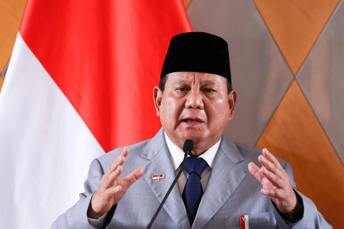 Indonesia's President Prabowo Subianto speaking as he attends a press conference with Malaysian Prime Minister Anwar Ibrahim (not pictured) during a meeting in Kuala Lumpur on Jan 27. Wearing a traditional Indonesian black hat and shirt, President Prabowo Subianto speaks to the camera in an Instagram video, asking his people how he can help them after his election last year. But while the Indonesian leader's mouth moves and his eyes blink, the words he utters are part of a fraudulent deepfake scam uncovered by police this month that has swindled Indonesians across 20 provinces. 