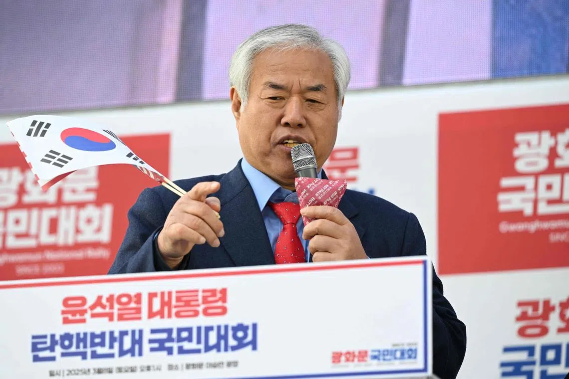 This picture taken on March 8, 2025 shows South Korean evangelical preacher Jun Kwang-hoon speaking during a rally to support impeached South Korean president Yoon Suk Yeol in Seoul. As a South Korean court prepares to announce whether the country's suspended president will be formally impeached over his martial law debacle, one firebrand pastor is preparing for "revolution". For weeks, Jun Kwang-hoon -- one of Yoon's most fervent defenders, who has claimed that the suspended president's December 3 martial law declaration was a "gift from god" -- has been prepping his followers to take action. (Photo by Jung Yeon-je / AFP) / To go with 'SKOREA-POLITICS-RELIGION-COURT-CHRISTIANITY, FOCUS' by SHIM Kyu-Seok