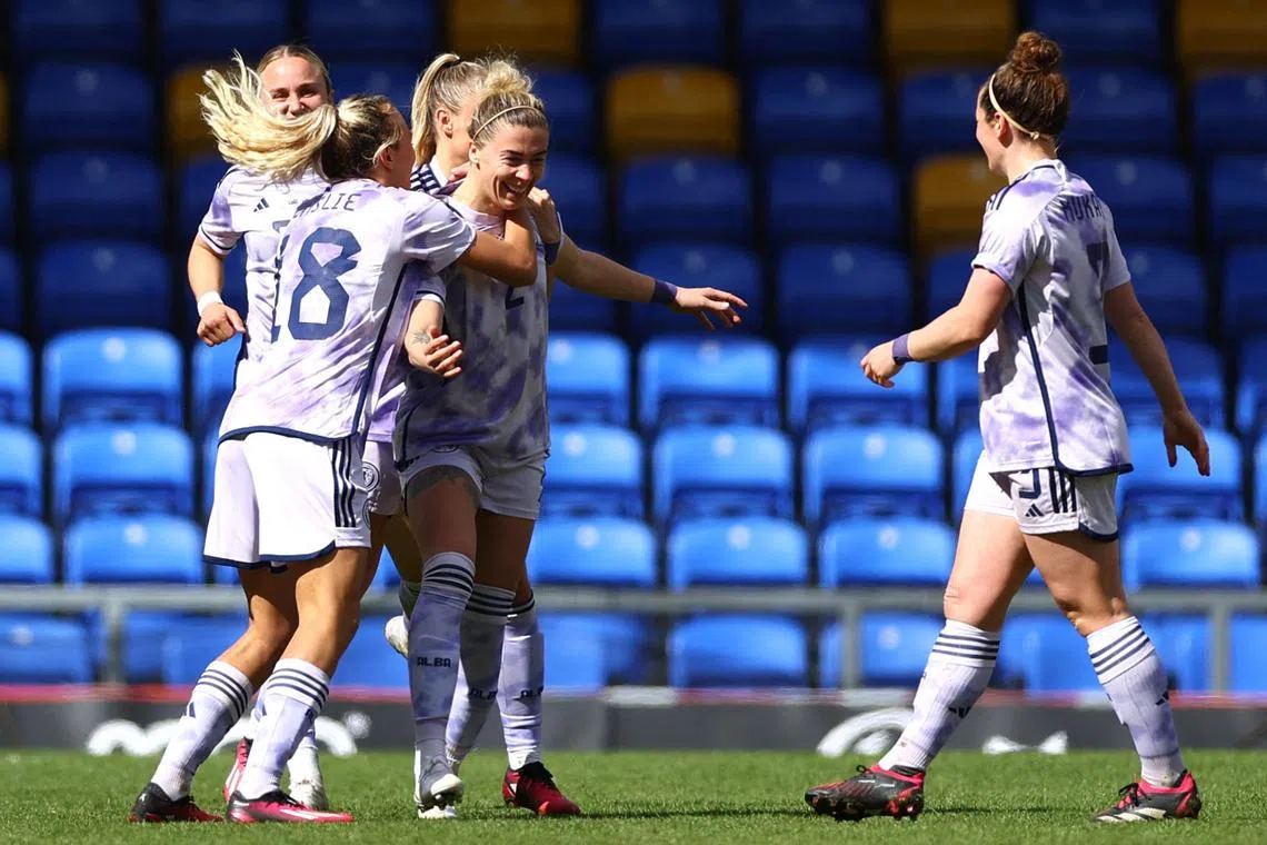 Scotland's Nicola Docherty celebrating with teammates after scoring the winner in their 1-0 success over Australia in an international friendly at the Cherry Red Records Stadium in London on Friday.