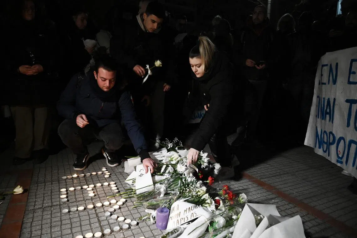 People light pay tribute to the victims of a train accident in the Tempi Valley near Larissa, Greece, on March 1, 2023. 