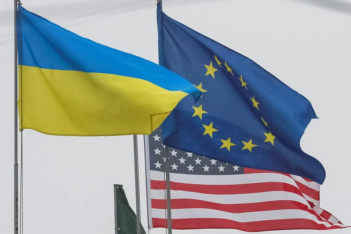 FILE PHOTO: State flags of Ukraine, European Union and U.S. flutter in central Kyiv, Ukraine December 6, 2021.  REUTERS/Gleb Garanich/File Photo
