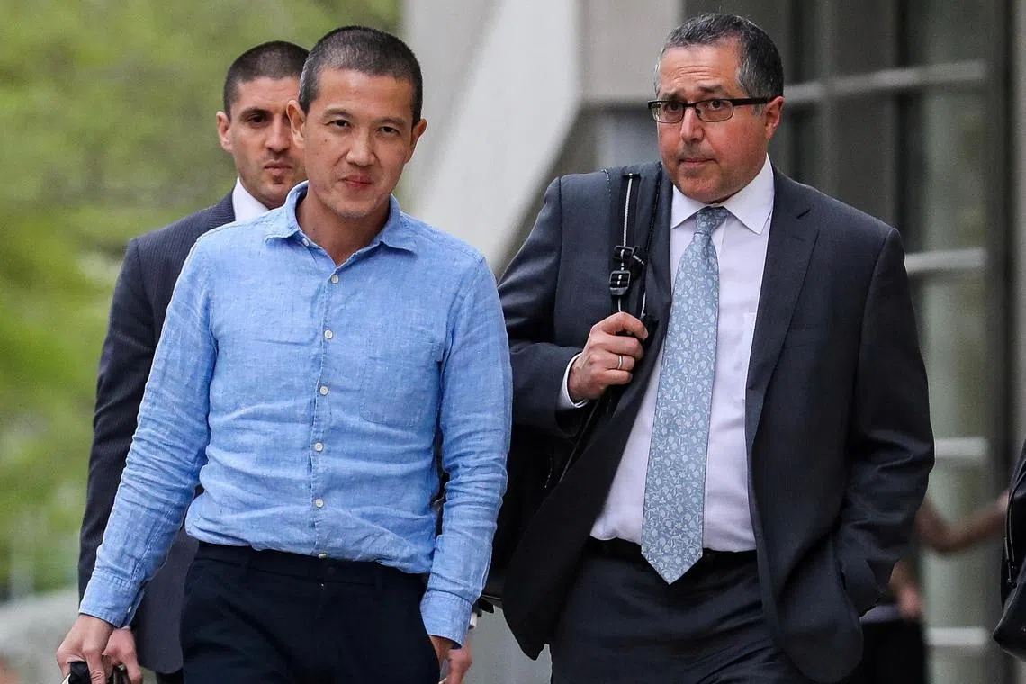 A 2019 photo shows ex-Goldman Sachs banker Roger Ng (left) and his lawyer Marc Agnifilo leaving a court hearing.