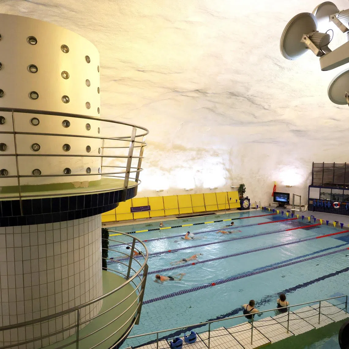 People swim in Itäkeskus Swimming Hall, Helsinki's underground swimming pool carved into solid bedrock, which can be drained and converted into a bomb shelter for 3,800 people, in Helsinki, Finland, May 6, 2026. REUTERS/Leonhard Foeger