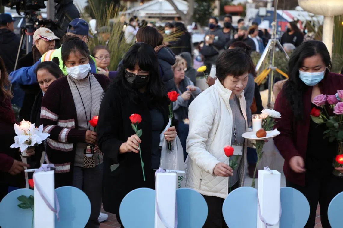 People gather for a candlelight vigil after a mass shooting during Chinese Lunar New Year celebrations in Monterey Park, California, U.S., Jan 24, 2023. Huu Can Tran, 72, fatally killed 10 people in a Los Angleles area dance hall before shooting himself. 