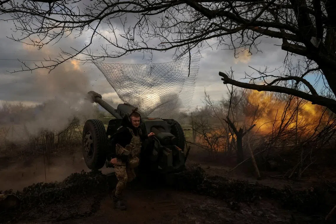 Ukrainian service members fire a howitzer D30 at a front line near Bakhmut in Ukraine on April 23.