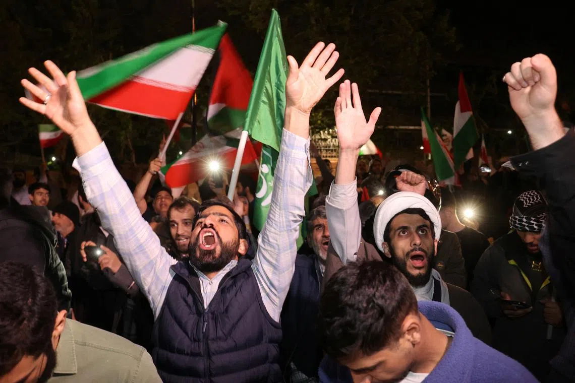 Iranian demonstrators react after the IRGC attack on Israel.