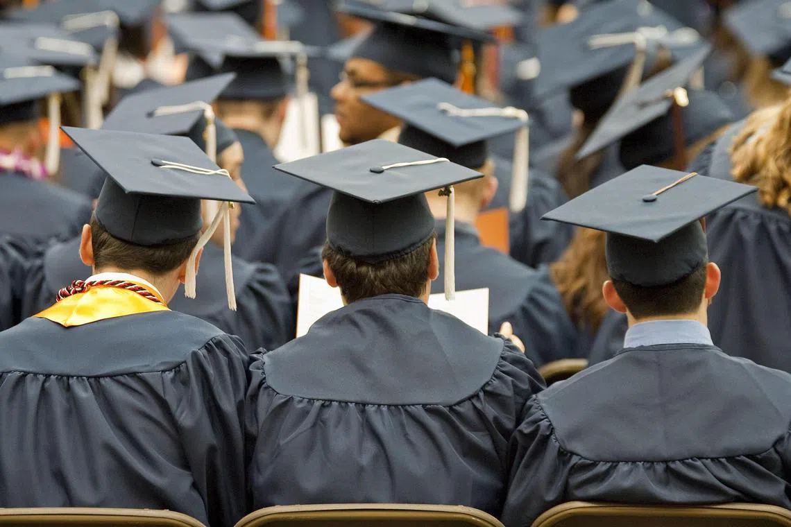 Graduates wearing mortarboards attend Syracuse University's commencement ceremony at the Carrier Dome in Syracuse, New York, U.S., on Sunday, May 16, 2010. Students entering one of the weakest job markets in history need to have the courage to speak the truth, "even when it's unpopular," JPMorgan Chase & Co. Chief Executive Officer Jamie Dimon told graduates. Photographer: Michael Okoniewski/Bloomberg