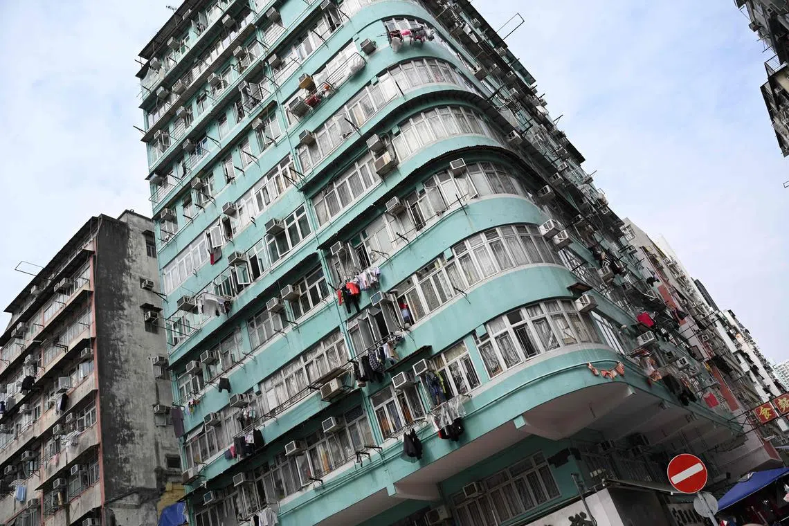 TOPSHOT - Photo taken on February 27, 2024 shows a view of residential buildings in Kowloon, Hong Kong. Hong Kong has dropped all property market curbs in a bid to boost buyer sentiment, the city's finance chief Paul Chan said in his annual budget speech on February 28. (Photo by Peter PARKS / AFP)