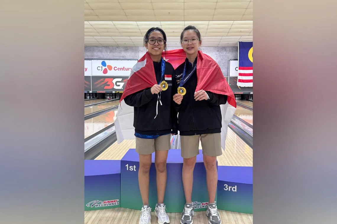 Nur Irdina Hazly (left) and Lim Shi En clinched the girls' doubles title at the Asian Youth Bowling Championships on Aug 23 with a 2,637-pinfall total.