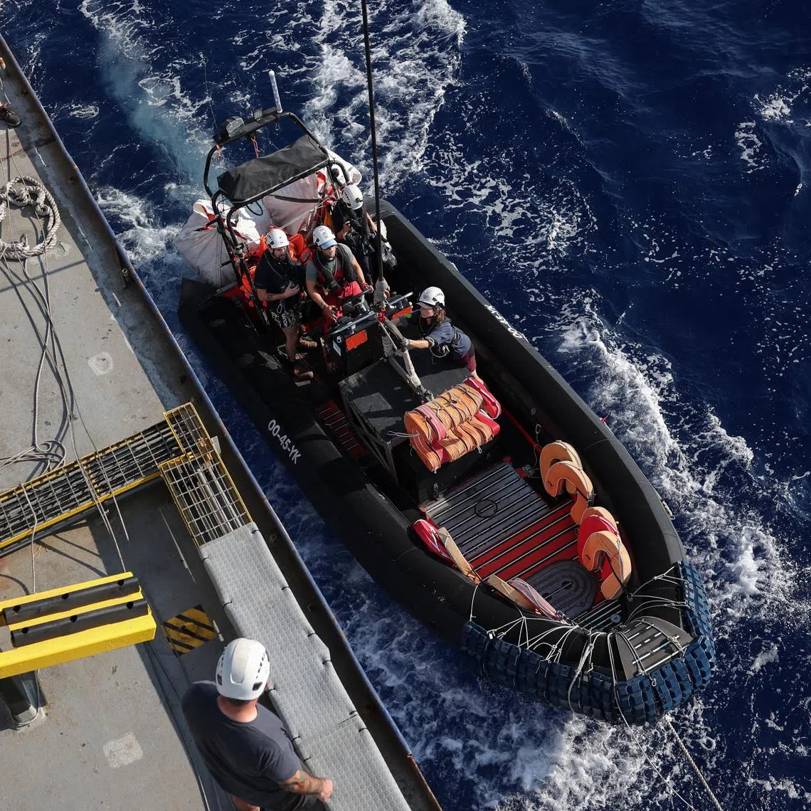 FILE PHOTO: Crew launches a rigid-hulled inflatable boat (RHIB), from the migrant search and rescue ship Sea-Watch 5, operated by German NGO Sea-Watch, in the search and rescue (SAR) zone in the central Mediterranean, off Libya, August 10, 2025. REUTERS/Louisa Gouliamaki/File Photo