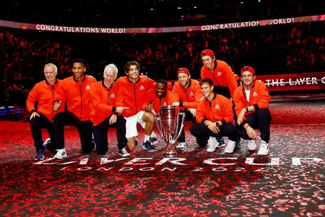 Tennis - Laver Cup - 02 Arena, London, Britain - September 25, 2022 Team World players and captain John McEnroe celebrate with the trophy after winning the Laver Cup Action Images via Reuters/Andrew Boyers