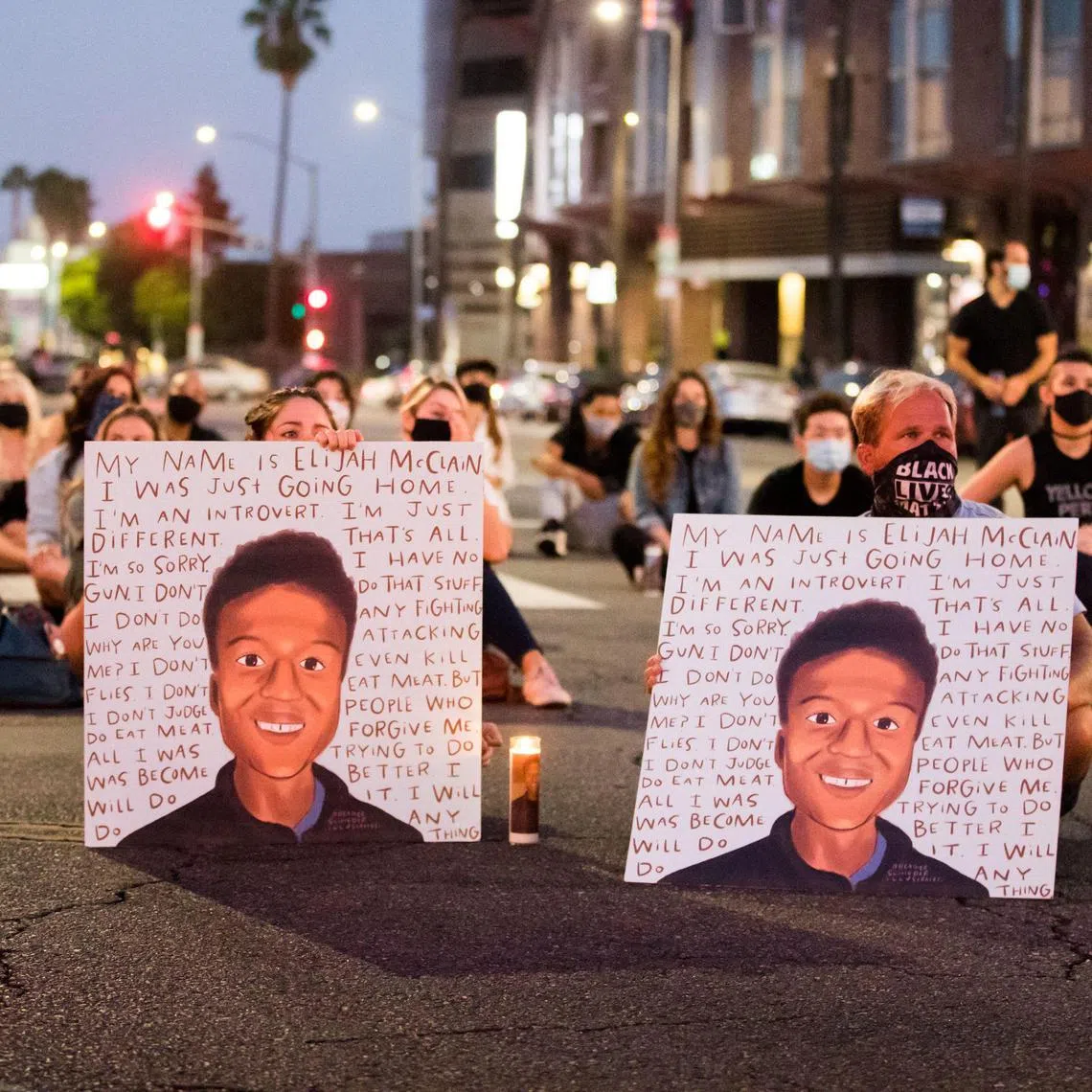 People gather at a candlelight vigil to demand justice for Elijah McClain in 2020.