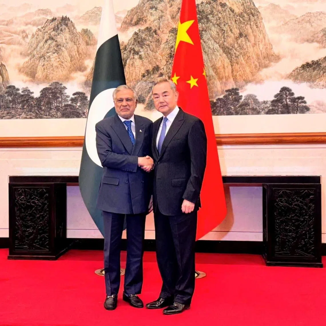 China's Foreign Minister Wang Yi and his Pakistani counterpart Ishaq Darat in Beijing on March 31. Pakistan has emerged as the key mediator between the US and Iran.
