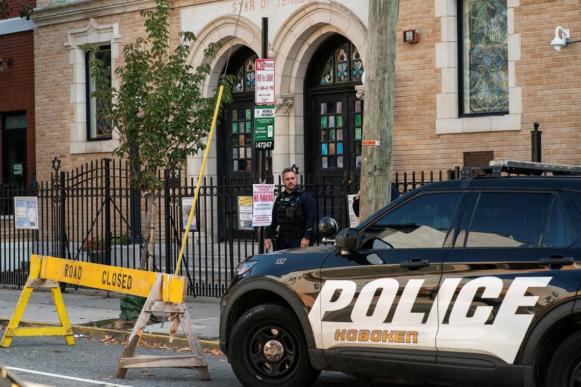 New Jersey police officers stand guard in front of the United Synagogue of Hoboken in New Jersey, on Nov 4, 2022.
